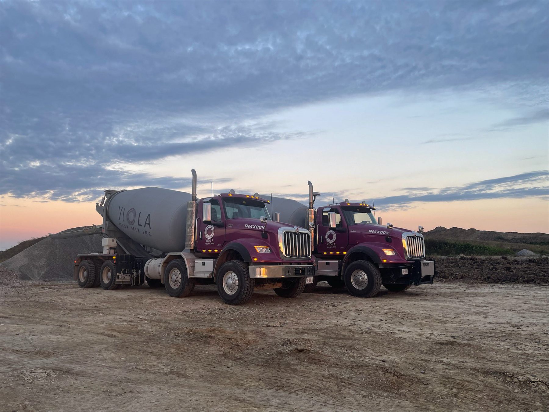 Viola Ready Mix concrete trucks at a job site at dusk